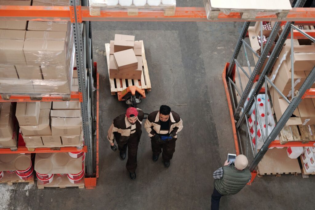 Employees carrying boxes in the warehouse
